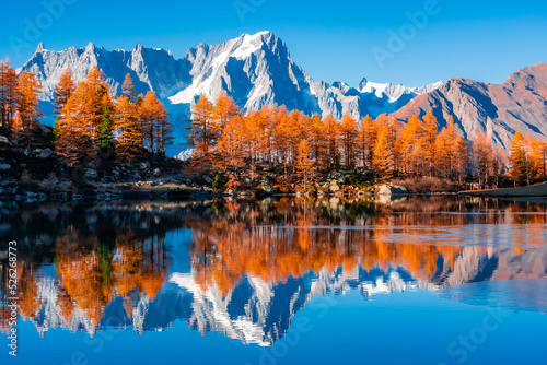 Beautiful reflection of Monte Rosa (Italian Alps) over Lake Arpy in autumn foliage Italy