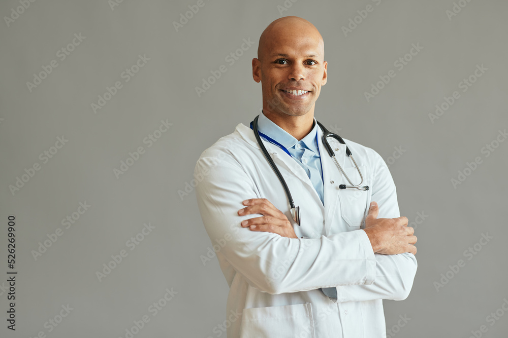 Happy African American doctor with arms crossed and looking at camera. Happy African American doctor with arms crossed and looking at camera.