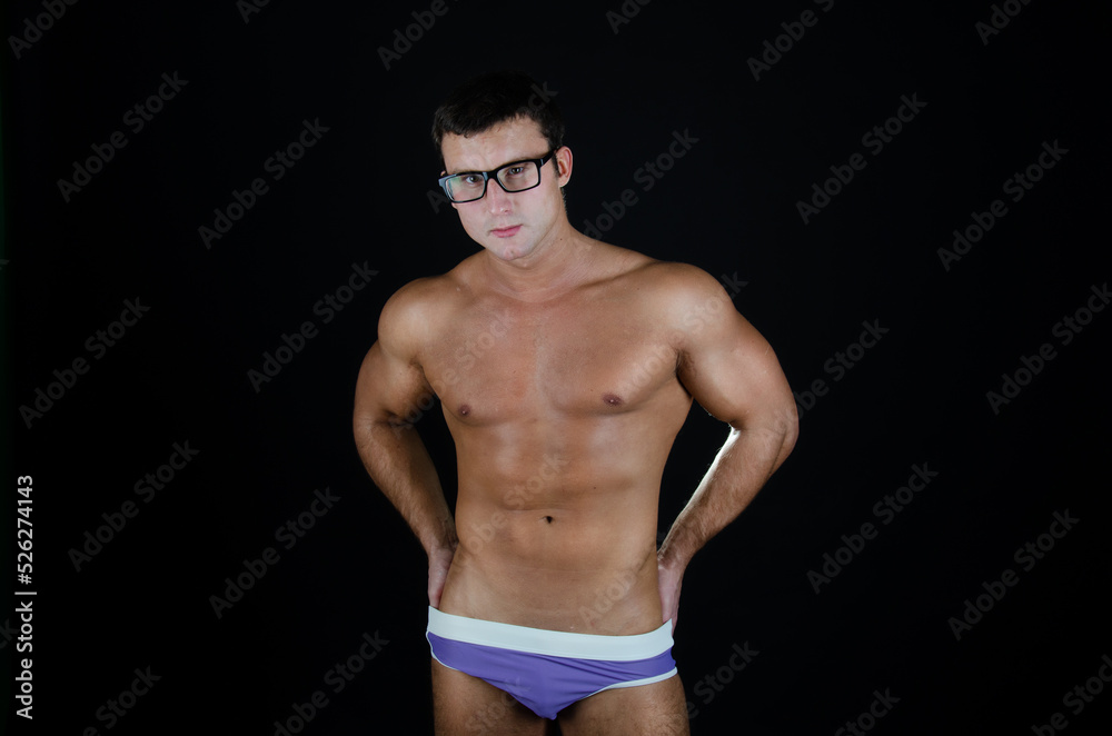 Young sexy guy posing in the studio. A man with a beautiful athletic body. Young sexy guy posing in the studio. A man with a beautiful athletic body.