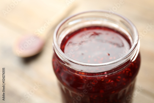 Homemade delicious raspberry jam on table, closeup