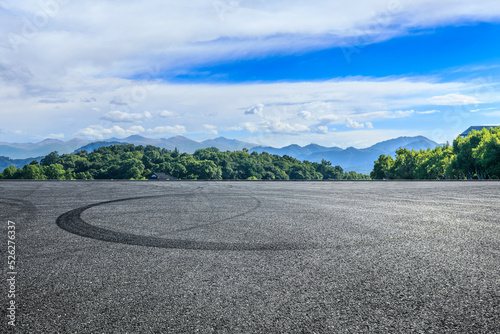 Empty asphalt road and green forest with mountain scenery © ABCDstock