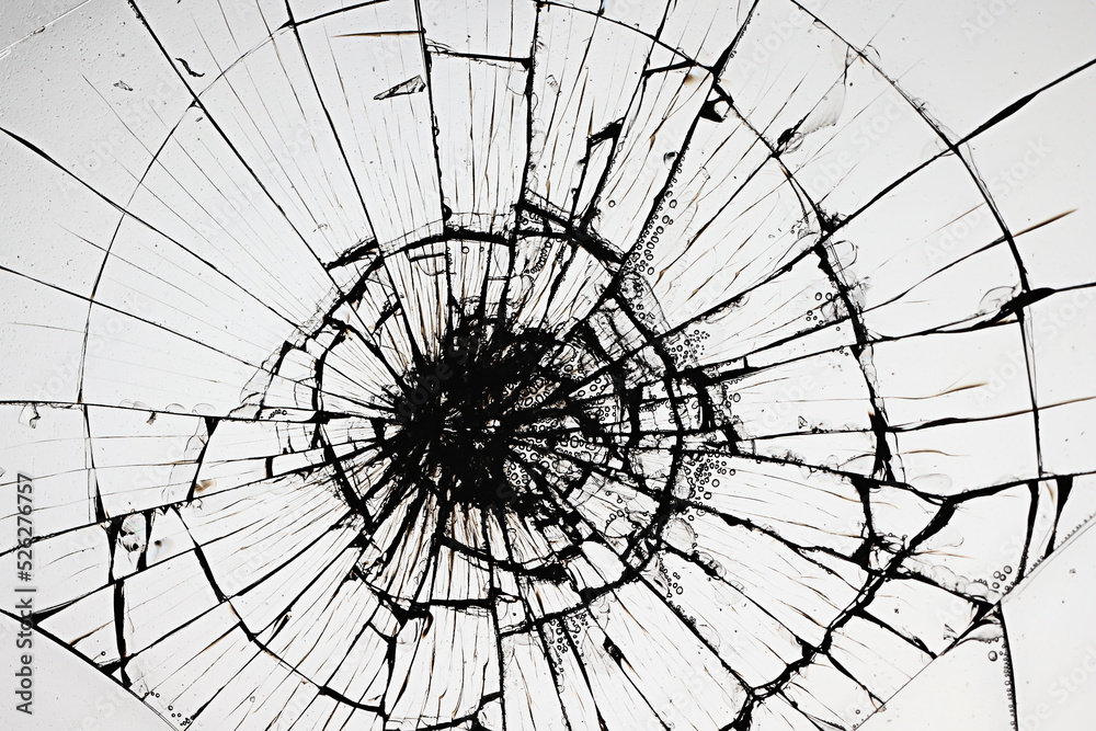 Obraz premium cracks on the glass impact on the glass, abstract background broken window damage