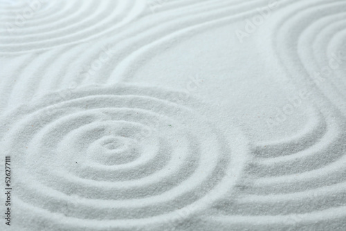 White sand with pattern as background. Zen, meditation, harmony