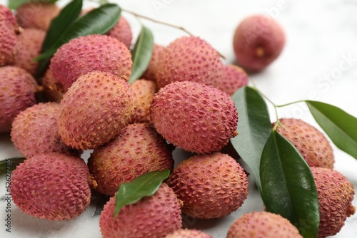 Fresh ripe lychee fruits on white table, closeup