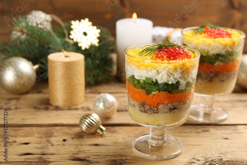 Traditional russian salad Mimosa and festive decor on wooden table. Space for text