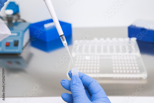 Doctor holding blood tube test in the research laboratory.Corona virus pandemic concept.Coronavirus vaccine development