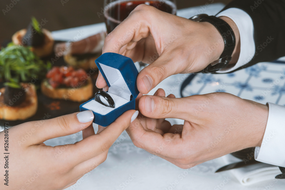 Fototapeta premium Man gives a woman payments smart ring.