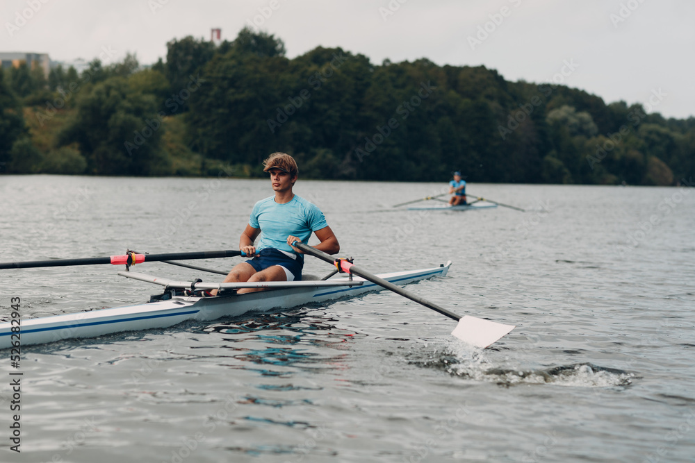 Sportsman single scull man rower rowing technique on boat. Paddle oar splash movement Sportsman single scull man rower rowing technique on boat. Paddle oar splash movement