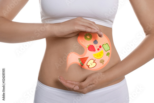 Woman with image of stomach full of food drawn on her belly against white background, closeup. Healthy eating habits
