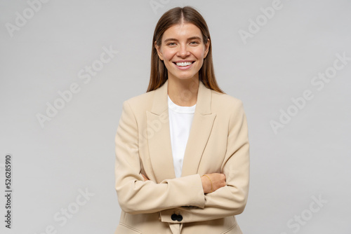 Portrait of confident successful business woamn with crossed arms isolated on gray studio background