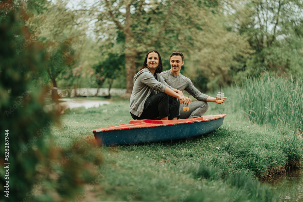 Couple sitting on a red kayak