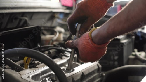 auto mechanic repairs car engine. auto repair shop. close-up