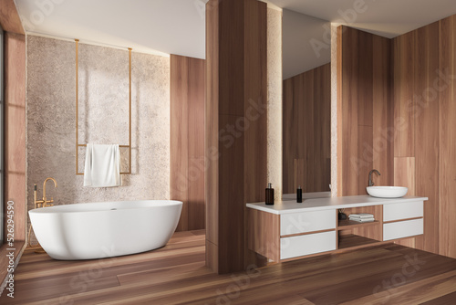 Stylish bathroom interior with sink and mirror  bathtub with towel