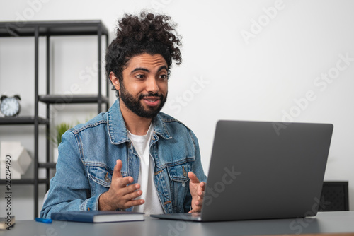 Businessman wearing casual wear is sitting having online confere photo