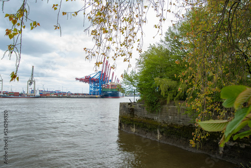 Hafenkrane und ein Containerschiff im Hamburger Hafen photo