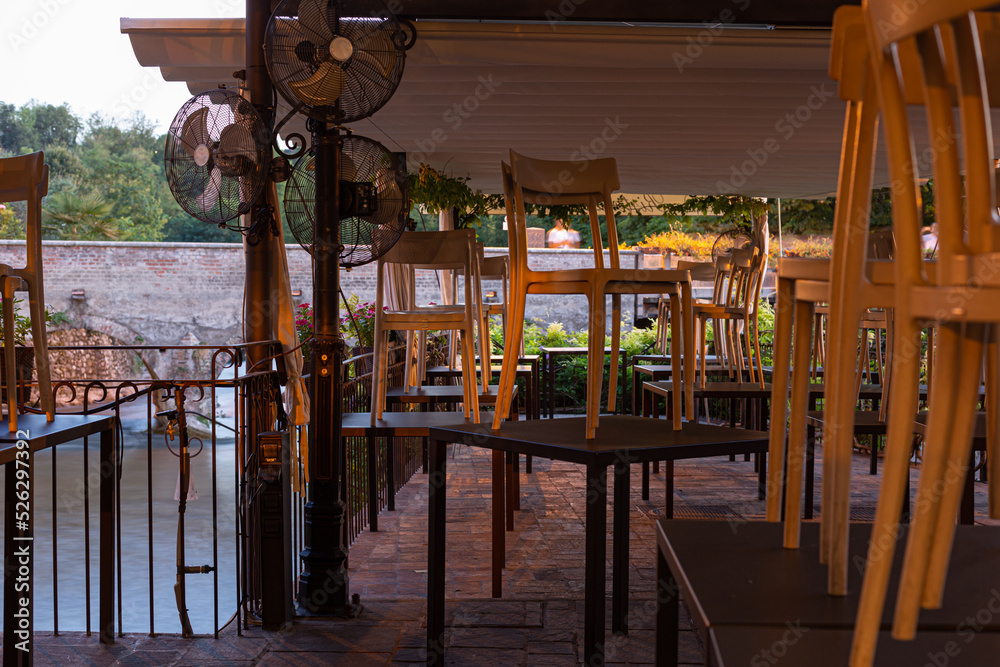 Chairs over tables at tourist restaurant, economic crisis concept Chairs over tables at tourist restaurant, economic crisis concept