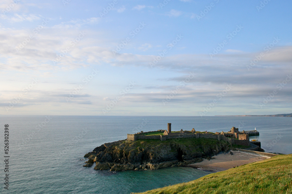 St. Patricks Isle with the ruins of Peel Castle and Fenella Beach at sunset