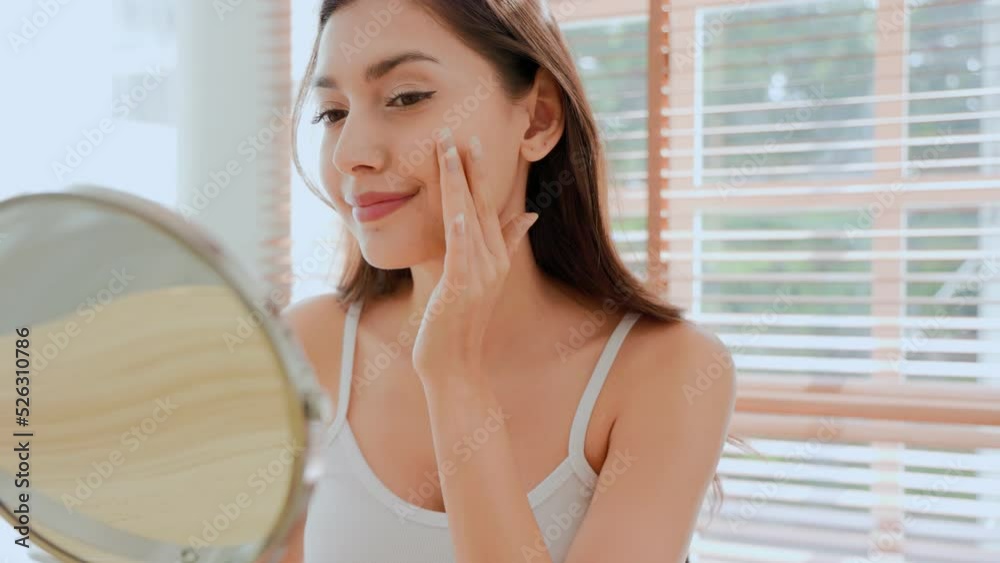 young woman applying lotion enjoying healthy skin care. young woman applying lotion enjoying healthy skin care.