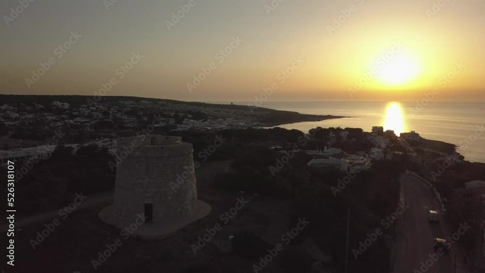 Drone shot of Torre de Son Ganxo and sunrise at Punta Prima, Menorca, Balearic Islands Drone shot of Torre de Son Ganxo and sunrise at Punta Prima, Menorca, Balearic Islands