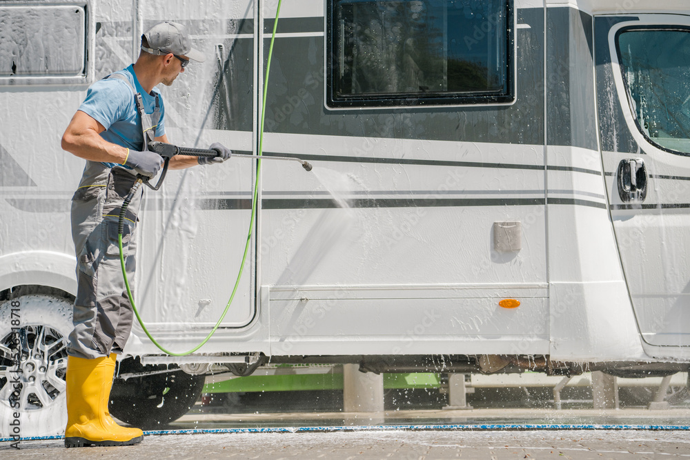 Fototapeta premium Man Pressure Washing His RV