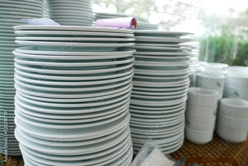 stack of many white color plate on table 