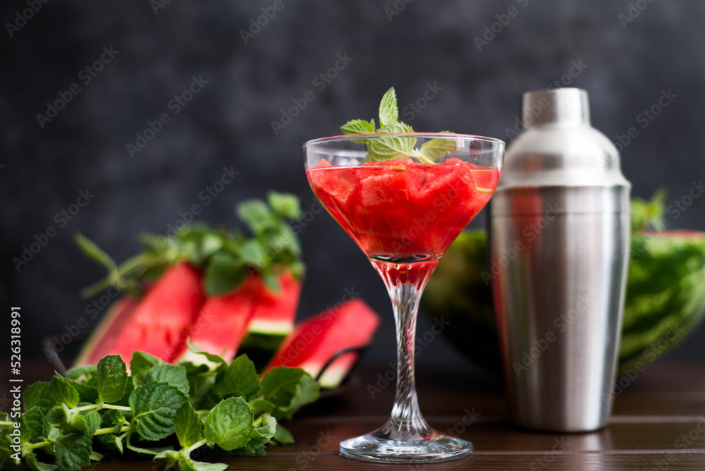 watermelon alcoholik or non- alcoholic cocktail with mint and shaker on dark background