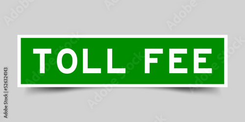 Green color square shape sticker label with word toll fee on gray background