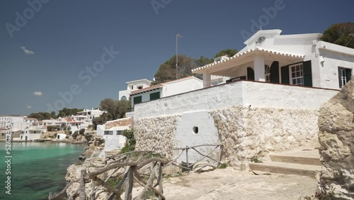 Turquoise water and whitewashed houses at Alcaufar, Menorca, Balearic Islands photo