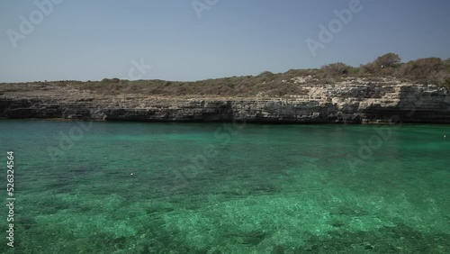 Turquoise water and Torre de Alcaufar landmark at Alcaufar, Menorca, Balearic Islands photo