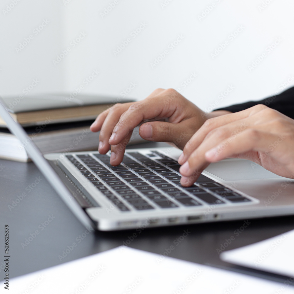 Financial businessmen use laptop to analyze marketing strategies and real estate data to reduce company taxes for their customers, Accounting and Tax concept. Financial businessmen use laptop to analyze marketing strategies and real estate data to reduce company taxes for their customers, Accounting and Tax concept.