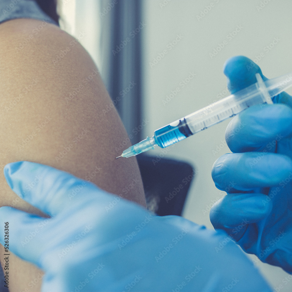 Vaccination of patients, Doctor provided a vaccine with a syringe against a new strain of virus or influenza in a modern hospital, Prevention and health care concept. Vaccination of patients, Doctor provided a vaccine with a syringe against a new strain of virus or influenza in a modern hospital, Prevention and health care concept.