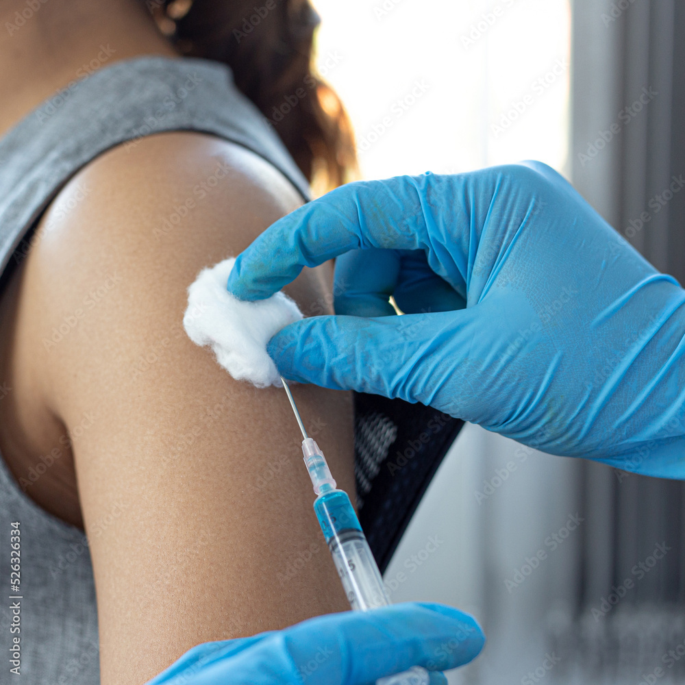 Vaccination of patients, Doctor provided a vaccine with a syringe against a new strain of  virus or influenza in a modern hospital, Prevention and health care concept.