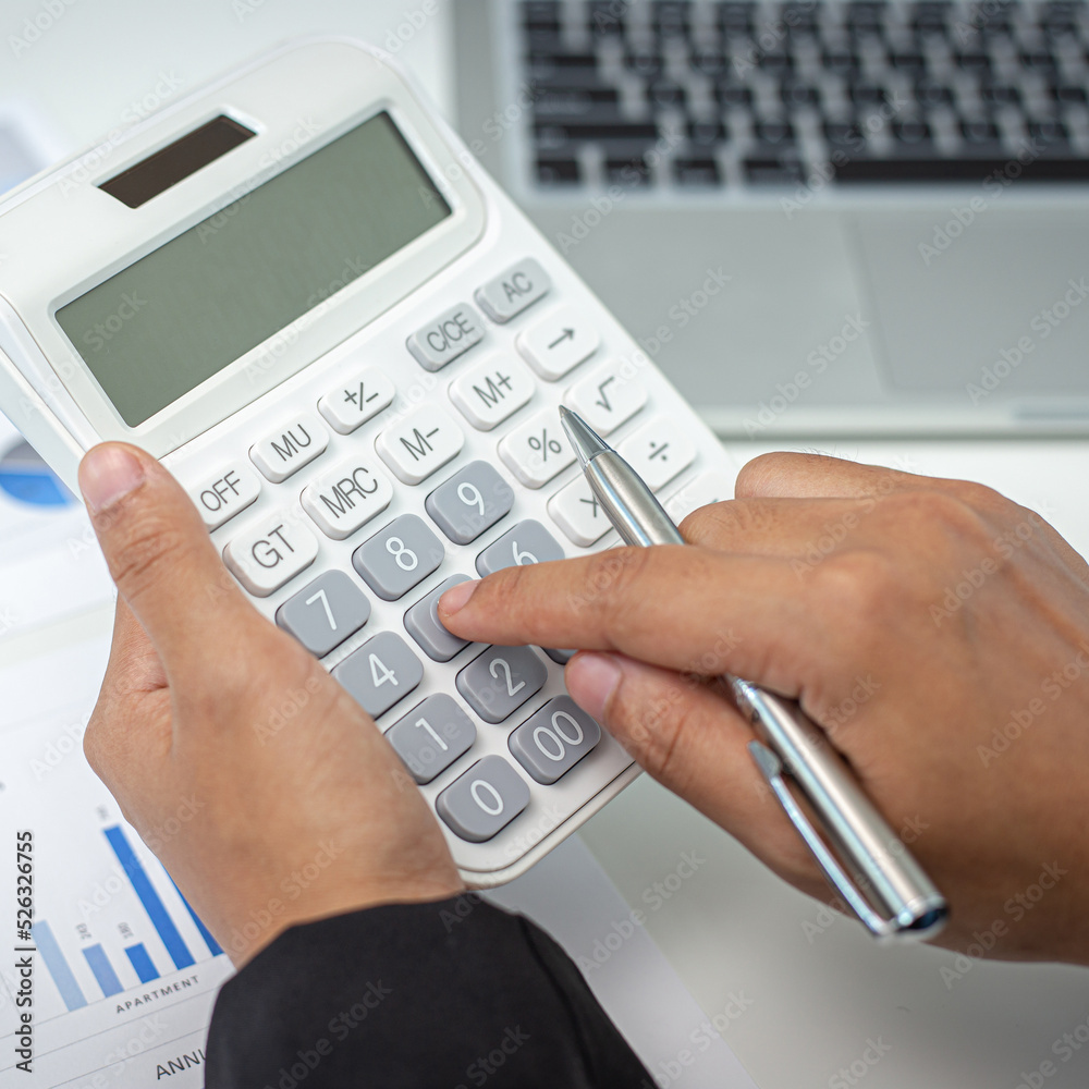 Businesswomen are calculating finances and analyzing market data with graphs and laptops at work, Business Financing Accounting Banking and tax system Concept. Businesswomen are calculating finances and analyzing market data with graphs and laptops at work, Business Financing Accounting Banking and tax system Concept.
