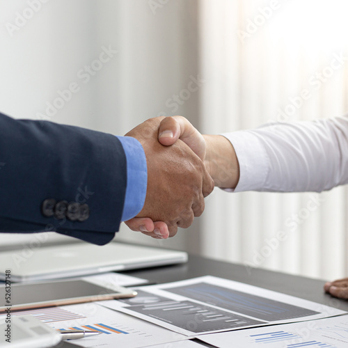 Both business people shake hands to celebrate financial success, Congratulation and greetings concept.
