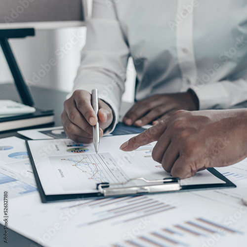 Brainstorm team, Marketers and financial accountants are discussing and analyzing charts to plan strategies to meet customer needs, Business success concept.