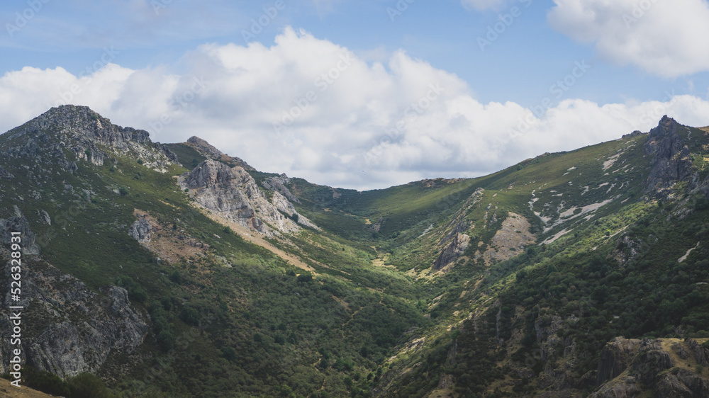 Mountain range covered in green grass and in a sunny day Mountain range covered in green grass and in a sunny day