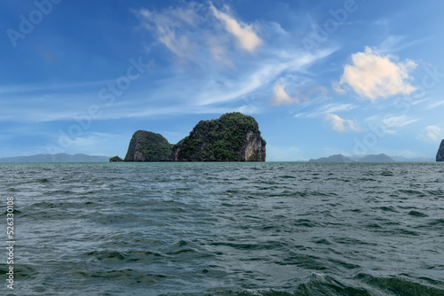 Phangna Bay near the Island of Phuket Thailand. Lovely rock in the middle of the ocean surrounded by mountains