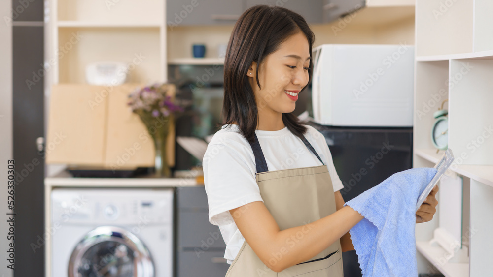 Home lifestyle concept, Young woman use fabric to wipe clean the decorations in the home showcase Home lifestyle concept, Young woman use fabric to wipe clean the decorations in the home showcase