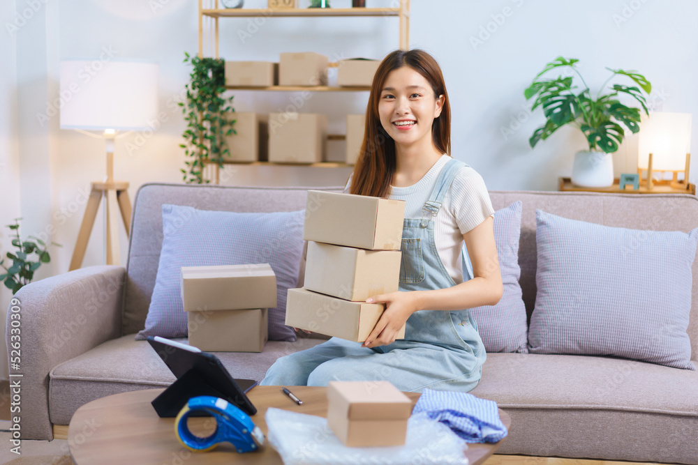 Online shopping concept, Female entrepreneur is holding parcel boxes to prepare sending to customer Online shopping concept, Female entrepreneur is holding parcel boxes to prepare sending to customer