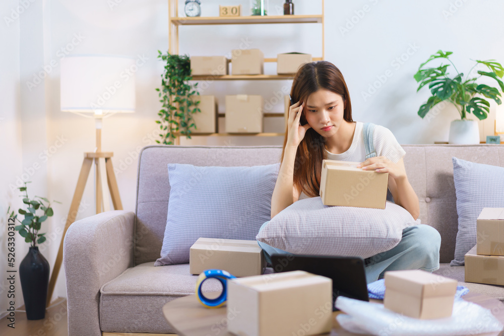 Online shopping concept, Female entrepreneur confused while reading data on tablet to write address Online shopping concept, Female entrepreneur confused while reading data on tablet to write address