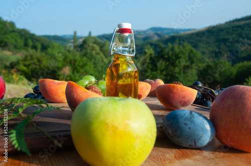 Olive oil and fruits on the wooden table on Rudnik mountain. photo