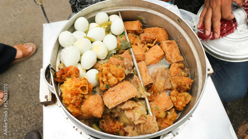 Bandung, INDONESIA - August 26, 2022: Meatballs,eggs, tofu, and dumplings that are in the pot in the Cuanki meatball cart. Meatball cuanki is one of the snacks from Bandung, West Java. photo