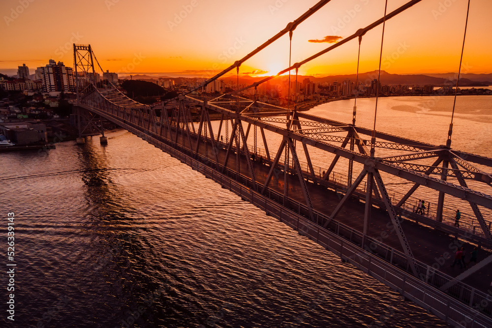 Fototapeta premium Cable stayed bridge with sunset sky in Florianopolis, Brazil. Aerial view