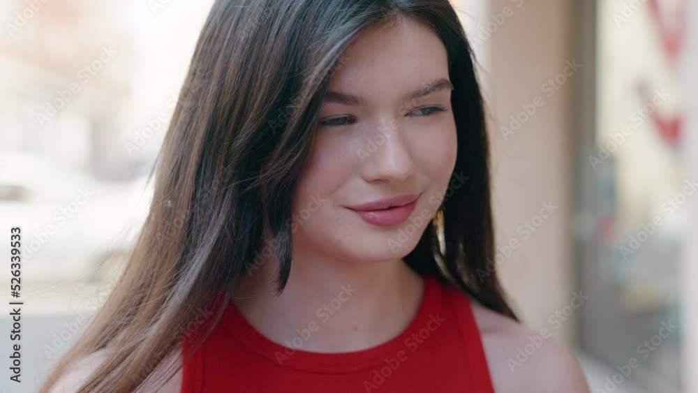 Young caucasian woman smiling confident looking to the side at street Young caucasian woman smiling confident looking to the side at street