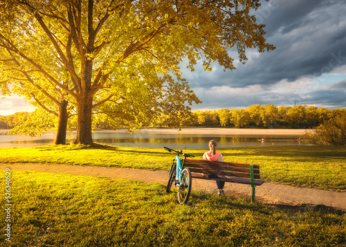Woman sitting on bench and ...