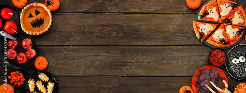 Wallpaper Mural Fun Halloween dinner party double border over a dark wood banner background. Top down view. Pizza, jack o lantern pumpkin pie, candy apples, eyeball spaghetti, snacks and spooky punch. Torontodigital.ca