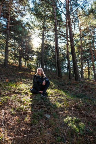 Blonde beautiful woman looking away in the middle of the nature