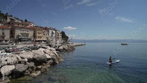 Boats in the harbour and restaurants and bars lining the sea front, Moscenicka Draga, Kvarner Bay photo