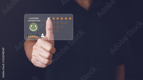 Customer or client service feedback and satisfaction rating concept. Man give thumbs up with five stars and smiley face for excellent survey result or rating to client who has good ranking on business