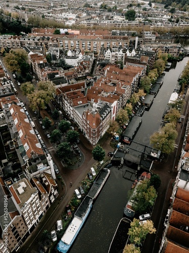 Canvas Print Aerial view of boats on canal surrounded by buildings in Amsterdam